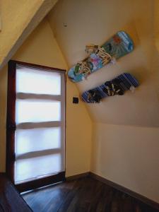 a attic room with a window and surfboards on the wall at Domos Blackdomes in Las Trancas