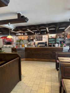 a bar in a restaurant with a counter and tables at Albergo Pontafel in Pontebba +8 photos