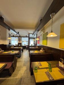 a dining room with wooden tables and benches at Albergo Pontafel in Pontebba