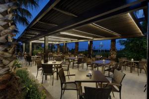 an outdoor patio with tables and chairs and a restaurant at Alba Resort Hotel - Ultra All Inclusive in Side