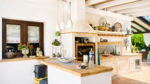 a kitchen with white cabinets and a counter at The Queens House in Agrigento