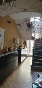 a kitchen with a ceiling with a table and a window at Des fleurs au balcon in Quintin