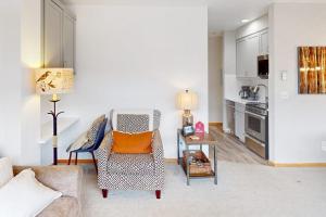 a living room with a chair and a table at River Bank Lodge 2924 in Keystone