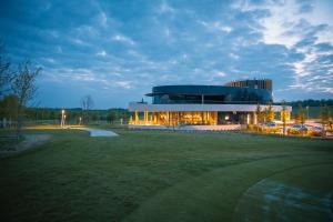 a building with a putting green in front of it at Bois d'Arlon Hotel & SPA in Arlon