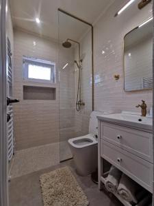 a bathroom with a toilet and a sink and a shower at Casa Olive Costinești in Costinesti