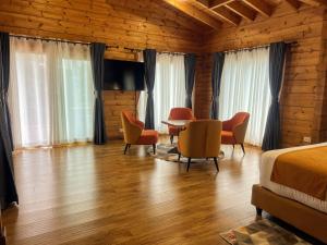 a bedroom with a bed and a table and chairs at Ridge Cabin Resort in Nairobi