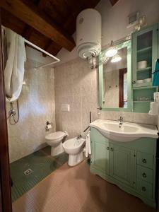a bathroom with a sink and a toilet and a mirror at La Cascina della Vachina in Poggio Bustone +134 photos