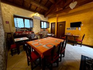 a dining room with a wooden table and chairs at La Cascina della Vachina in Poggio Bustone