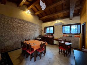 a dining room with a wooden table and chairs at La Cascina della Vachina in Poggio Bustone