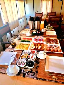 a long table with many different types of food at Roaming Desert Luxury Camp in Lac Yasmins