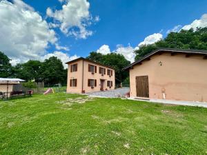 a large yard with a building and a playground at La Cascina della Vachina in Poggio Bustone