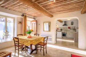 a kitchen and dining room with a table and chairs at La bastide d'emilie sud est in Saint Antonin du Var