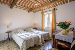 a bedroom with two beds and a window at La bastide d'emilie sud est in Saint Antonin du Var