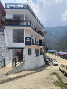 a white building with balconies on the side of it at Trishool inn residency in Chandrāpuri