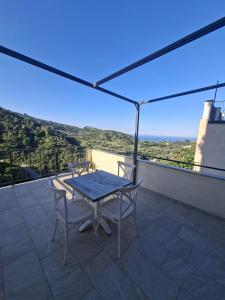 a table and chairs on a balcony with a view at La Casa di Mimma in Badolato