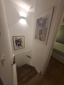 a staircase with a light and pictures on the wall at La Casa di Mimma in Badolato