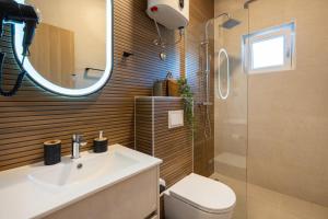 a bathroom with a sink and a toilet and a mirror at Guest house AnĐela in Neum +60 photos