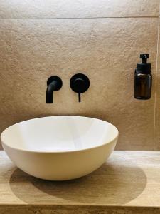 a white bowl sink on a counter in a bathroom at Hotel Ti' Pelican in Saint-Pierre
