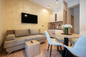 a living room with a couch and a table at Guest house AnĐela in Neum