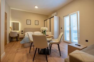 a living room with a table and a room with a bed at Guest house AnĐela in Neum