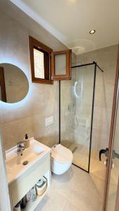 a bathroom with a toilet and a sink and a shower at Aurea in Dhërmi +23 photos