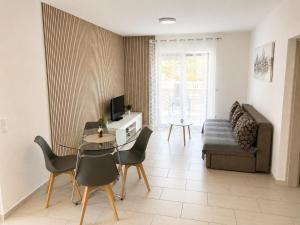 a living room with a table and chairs and a couch at Apartments Adria in Vir