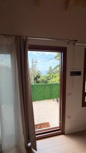 a sliding glass door with a view of a yard at Aurea in Dhërmi