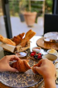 a table with a plate of bread and other food at Casa Martini in Bonifacio
