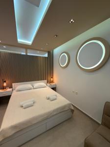 a bedroom with a large bed and a large mirror at Lux In A Box, Apartments In the center in Nea Kallikrateia