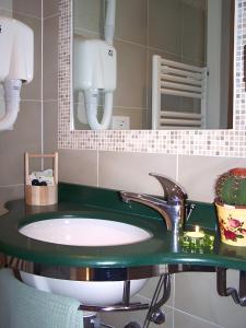 a bathroom with a sink and a mirror at Hotel Dolores in Rimini
