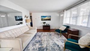 a living room with a white couch and a table at Cape Bay Cottage in North Cape May