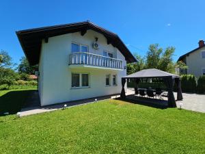 a house with a gazebo in a yard at Villa Aylin in Bihać