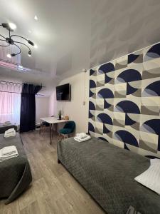 a bedroom with a bed and a table and a wall at Готель Гайсин «Тіроль» in Haysyn +46 photos