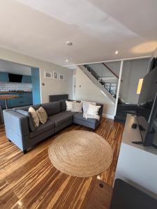 a living room with a couch and a table at Small and Snug The Old Store in Broadstairs