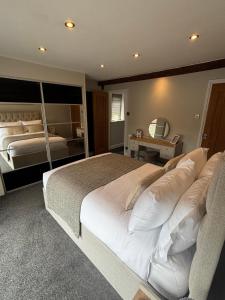 a bedroom with a large white bed and a mirror at Small and Snug The Old Store in Broadstairs