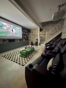 a living room with couches and a flat screen tv at Maison Maün in Gelos