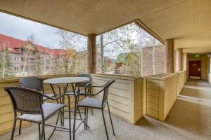 a porch with chairs and a table and some windows at 2914 River Bank Lodge - Keystone in Keystone