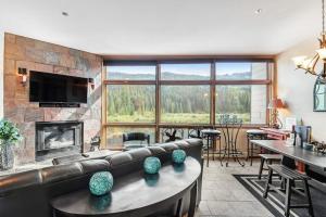 a living room with a couch and a fireplace at 2914 River Bank Lodge - Keystone in Keystone