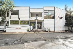 an empty parking lot in front of a white building at 2914 River Bank Lodge - Keystone in Keystone