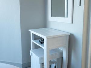 a white dressing table with two shelves in a room at Oliverio Seaside Living in Sedgefield