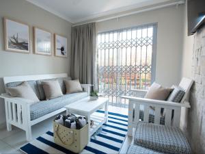 a living room with a couch and a window at Oliverio Seaside Living in Sedgefield
