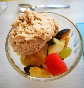 a glass bowl with a piece of cake and fruit at Hotel Dolores in Rimini