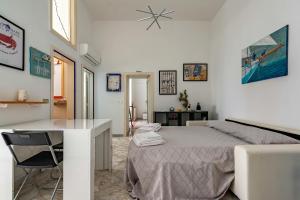 a bedroom with a bed and a desk in it at 15min Polignano Puglia Historical Center Terrace in Conversano