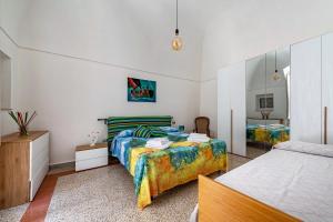 a bedroom with two beds and a mirror at 15min Polignano Puglia Historical Center Terrace in Conversano