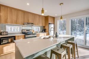 a kitchen with a large island with bar stools at Private Pool & Spa - Chalet Bella Vista in Saint Come