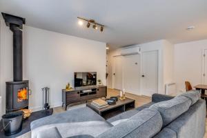 a living room with a couch and a fireplace at Private Pool & Spa - Chalet Bella Vista in Saint Come