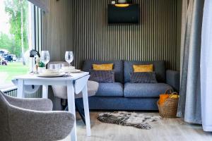a living room with a blue couch and a table at ''Zunds'' Camping house in Riga