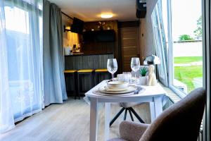 a white table with wine glasses on top of it at ''Zunds'' Camping house in Riga +12 photos