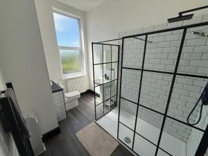 a bathroom with a glass shower and a toilet at Plessey Road LARGE 5 Bed, 2 Bath, Contractors NEW in Cowpen +37 photos