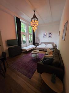 a living room with a couch and a bed at Barbera Guesthouse Hotel Apartments - Experience local life in the Old Centre in Haarlem